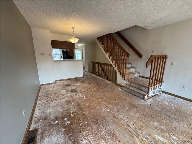 unfurnished living room with a textured ceiling