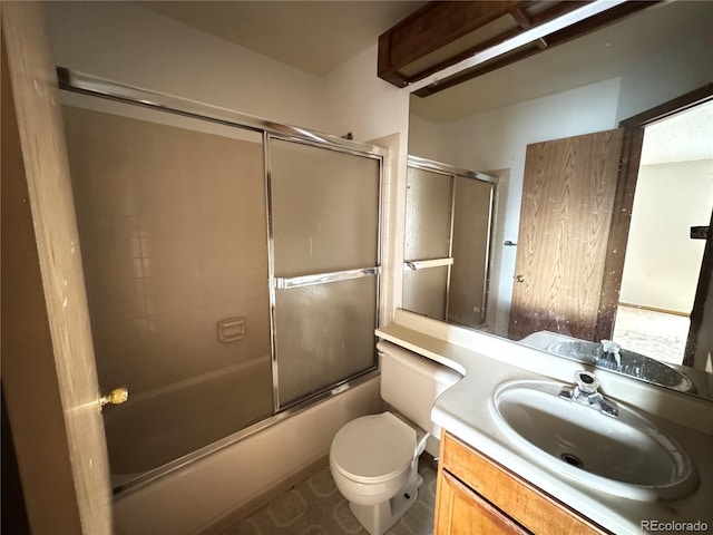 full bathroom featuring toilet, vanity, and shower / bath combination with glass door