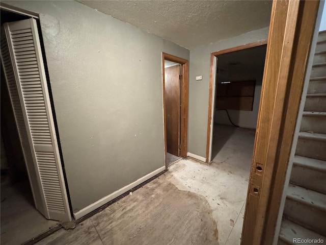 hallway featuring a textured ceiling