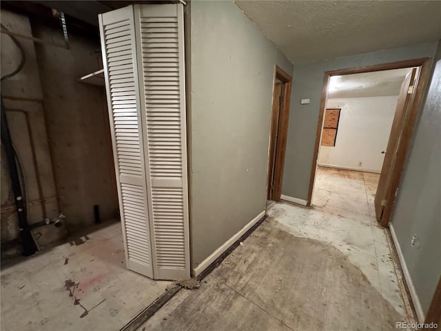 hallway with a textured ceiling