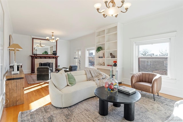 living room with an inviting chandelier, hardwood / wood-style floors, and a healthy amount of sunlight