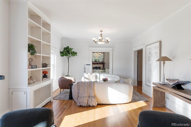 interior space featuring a notable chandelier, hardwood / wood-style floors, and crown molding