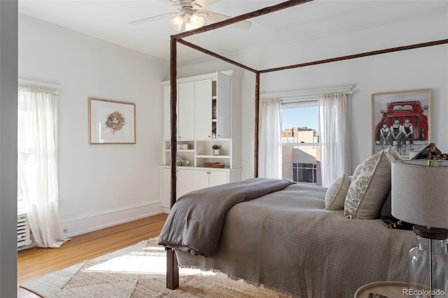 bedroom with ceiling fan, light hardwood / wood-style flooring, and crown molding