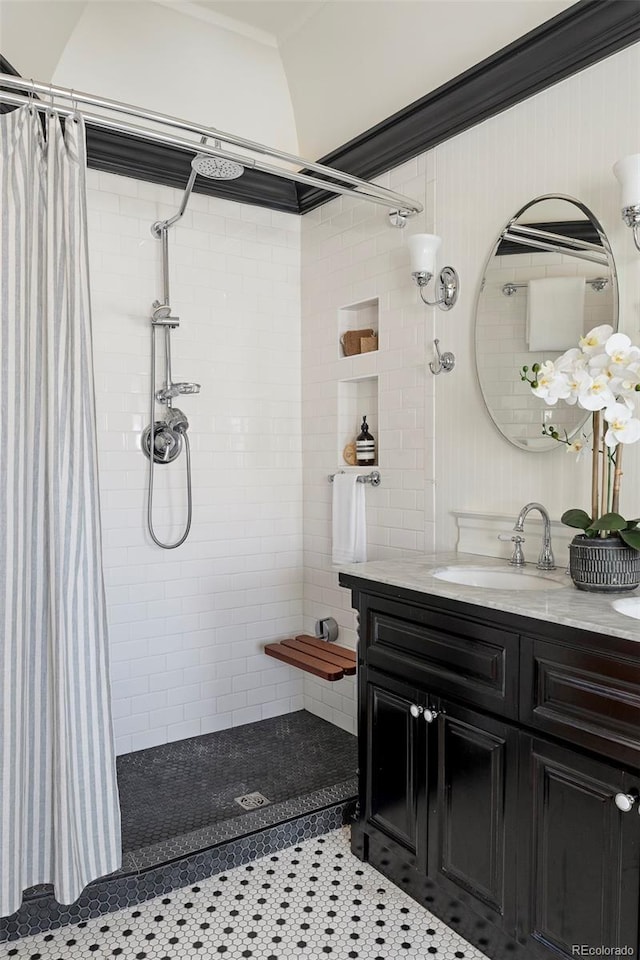 bathroom with vanity, walk in shower, tile patterned floors, and crown molding