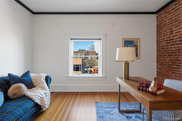 office space featuring crown molding, brick wall, and hardwood / wood-style flooring