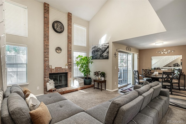 7684 S Monaco Cir, Centennial, CO 80112 - living area featuring high vaulted ceiling, carpet flooring, plenty of natural light, and a brick fireplace