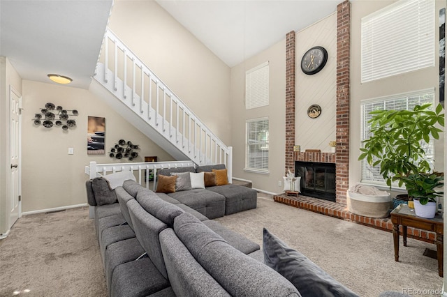 7684 S Monaco Cir, Centennial, CO 80112 - living area featuring high vaulted ceiling, carpet flooring, stairway, and a brick fireplace