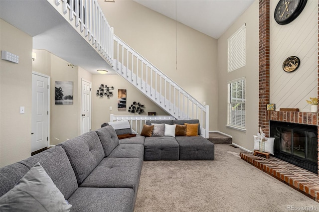 7684 S Monaco Cir, Centennial, CO 80112 - living area with stairs, a towering ceiling, carpet flooring, and a brick fireplace