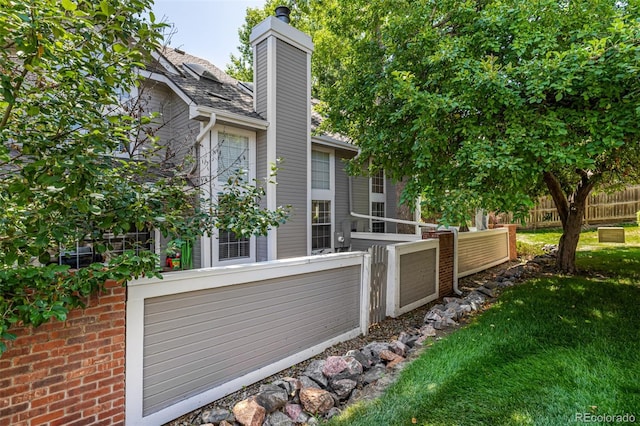 7684 S Monaco Cir, Centennial, CO 80112 - view of side of property with a chimney and a garage