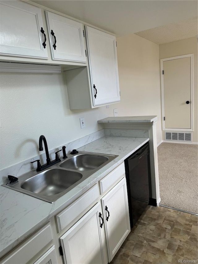 kitchen featuring a sink, dishwasher, dark colored carpet, white cabinetry, and visible vents