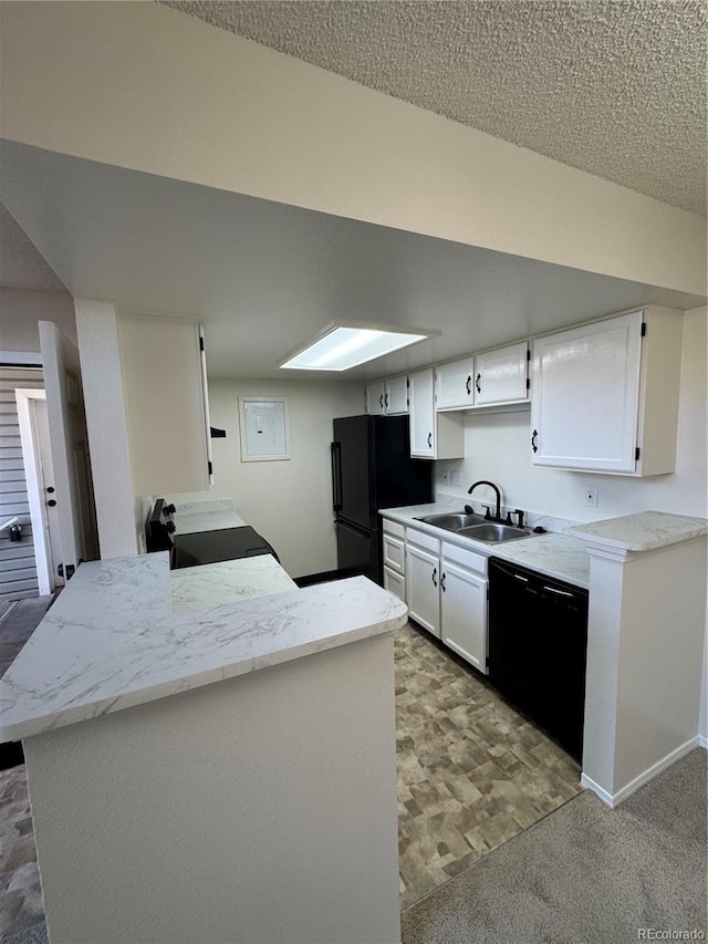 kitchen with white cabinets, light carpet, a sink, and black appliances