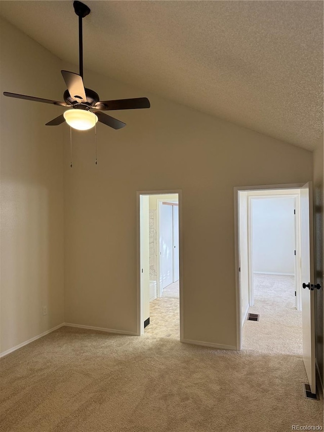 empty room with ceiling fan, visible vents, light carpet, and lofted ceiling