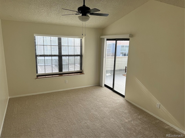 unfurnished room with lofted ceiling, light carpet, baseboards, a textured ceiling, and a ceiling fan