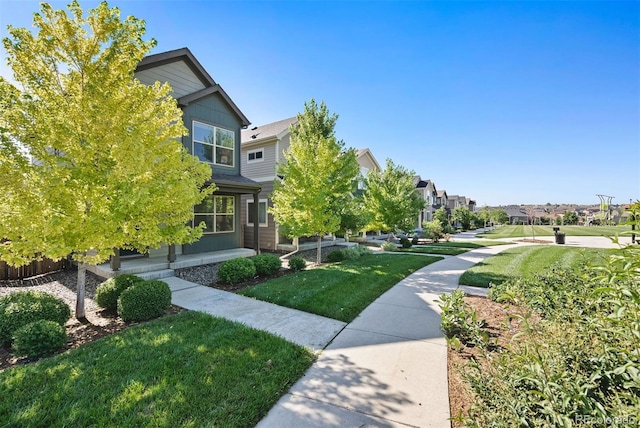 12777 Ulster St, Thornton, CO 80602 - view of community featuring a lawn and a residential view
