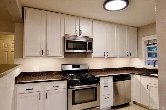 kitchen featuring white cabinets, appliances with stainless steel finishes, and sink