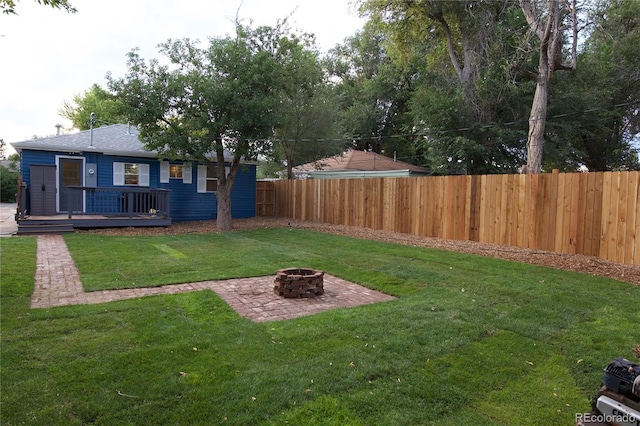 view of yard featuring a fire pit and a wooden deck