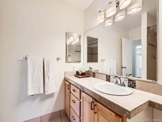 7755 E Quincy Ave Unit 301A7, Denver, CO 80237 - bathroom featuring vanity, tile patterned floors, and a shower