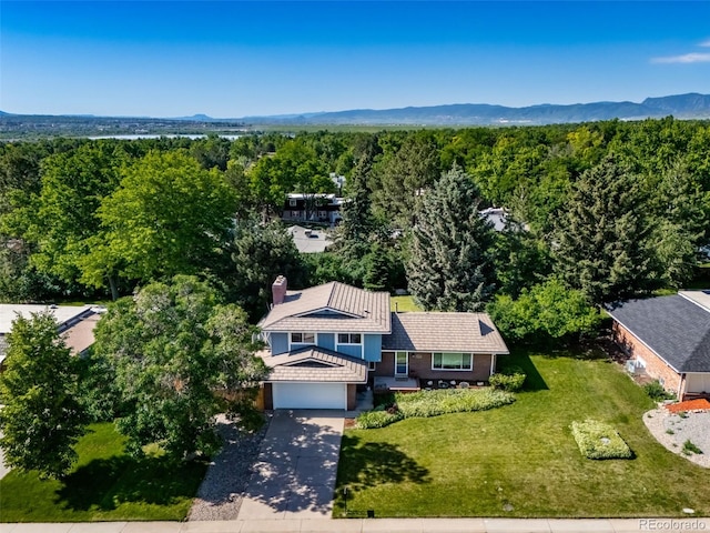 5404 W Rowland Pl, Littleton, CO 80128 - view of subject property featuring a heavily wooded area and a mountainous background