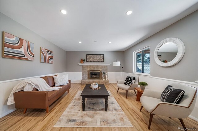5404 W Rowland Pl, Littleton, CO 80128 - living room with a wainscoted wall, wood finished floors, recessed lighting, and a fireplace
