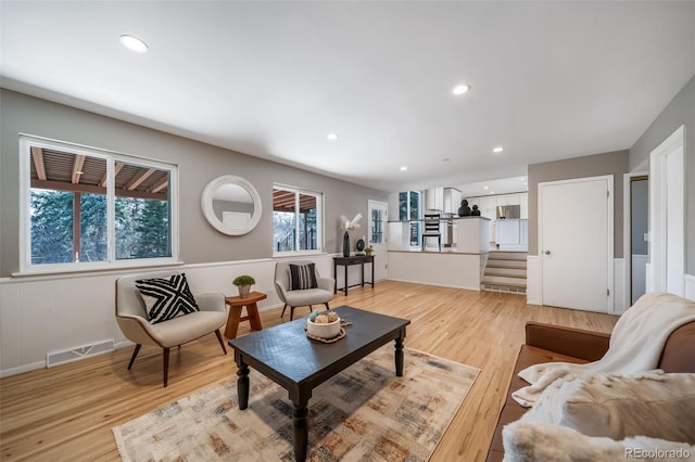 5404 W Rowland Pl, Littleton, CO 80128 - living area featuring healthy amount of natural light, light wood-style flooring, stairway, and recessed lighting