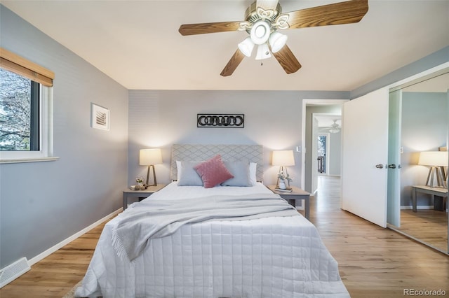 5404 W Rowland Pl, Littleton, CO 80128 - bedroom with light wood finished floors, a ceiling fan, and a closet