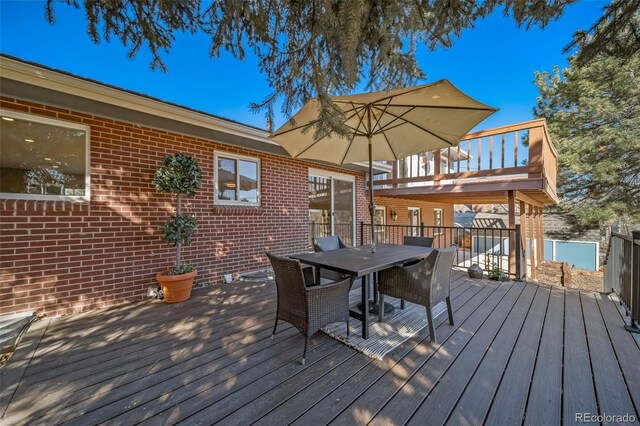 5404 W Rowland Pl, Littleton, CO 80128 - wooden deck featuring outdoor dining area