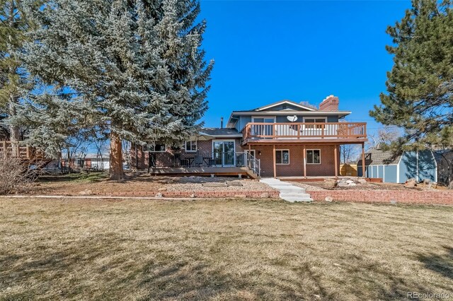 5404 W Rowland Pl, Littleton, CO 80128 - back of property with a deck, a chimney, brick siding, a lawn, and a storage unit
