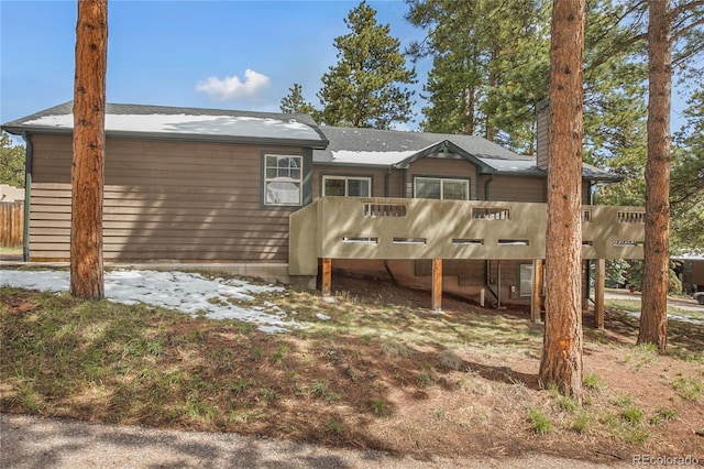 back of property featuring a deck and a chimney