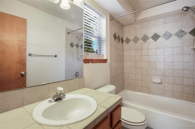 full bath featuring toilet, vanity, and washtub / shower combination