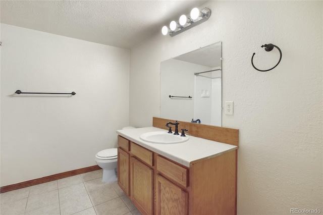 bathroom featuring vanity, toilet, a textured ceiling, tile patterned floors, and baseboards