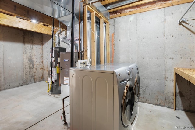 unfinished basement featuring washer and clothes dryer and gas water heater