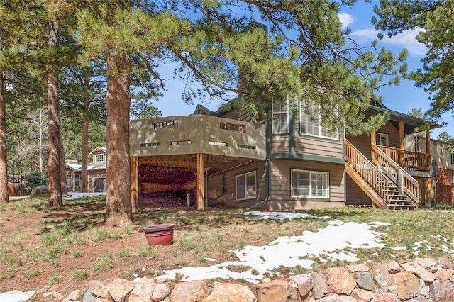 rear view of house with a deck and stairs
