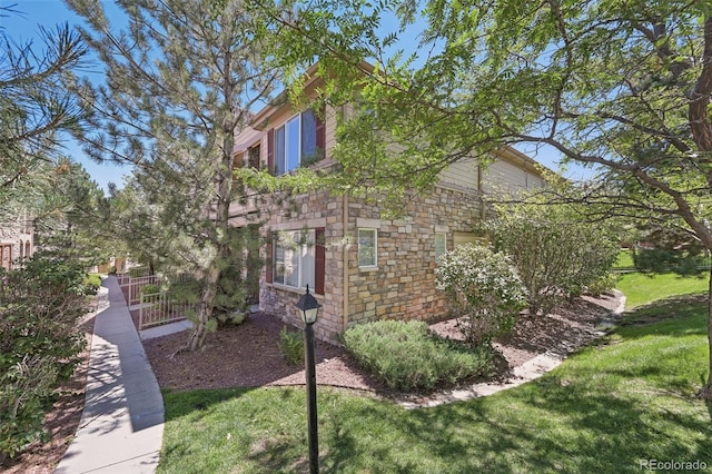 view of side of home with a lawn