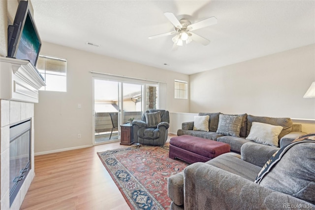 living room featuring ceiling fan and light wood-type flooring