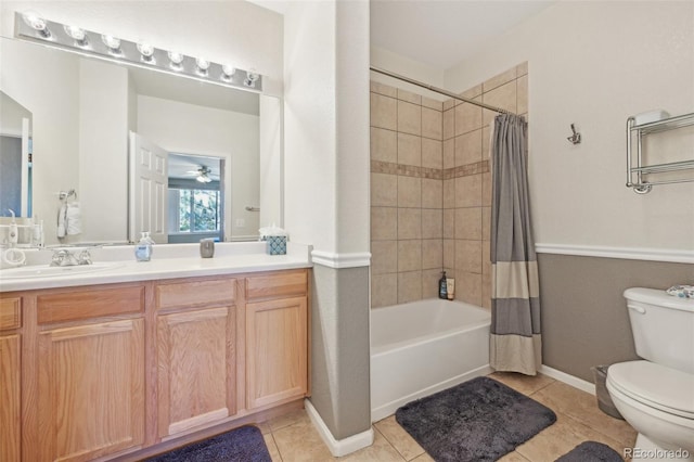 full bathroom with shower / tub combo with curtain, toilet, vanity, and tile patterned floors