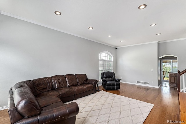 5326 E Hamilton Ave, Castle Rock, CO 80104 - living room featuring recessed lighting, wood finished floors, ornamental molding, and arched walkways