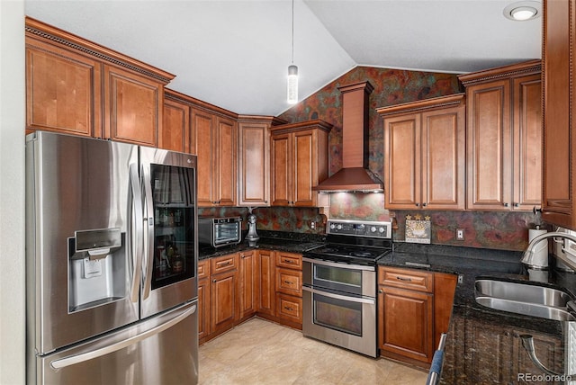 5326 E Hamilton Ave, Castle Rock, CO 80104 - kitchen with stainless steel appliances, wall chimney exhaust hood, vaulted ceiling, brown cabinetry, and pendant lighting