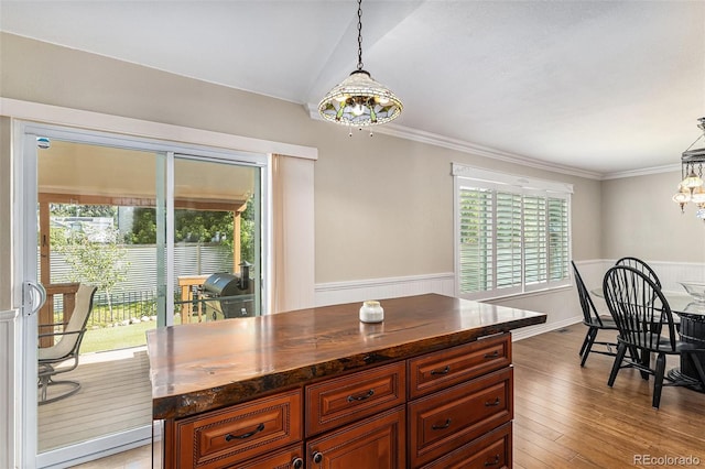 5326 E Hamilton Ave, Castle Rock, CO 80104 - dining space with wainscoting, a chandelier, light wood-type flooring, and ornamental molding