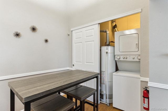 washroom with stacked washer and dryer and gas water heater