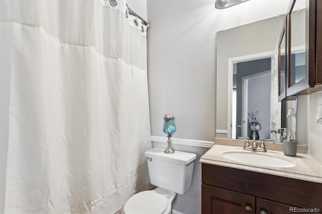 bathroom featuring toilet and vanity