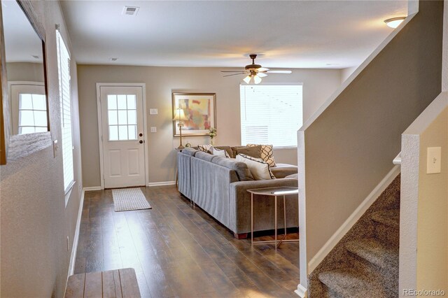 entryway featuring baseboards, visible vents, ceiling fan, stairway, and dark wood-type flooring