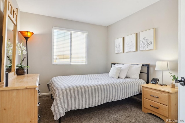 bedroom featuring dark carpet