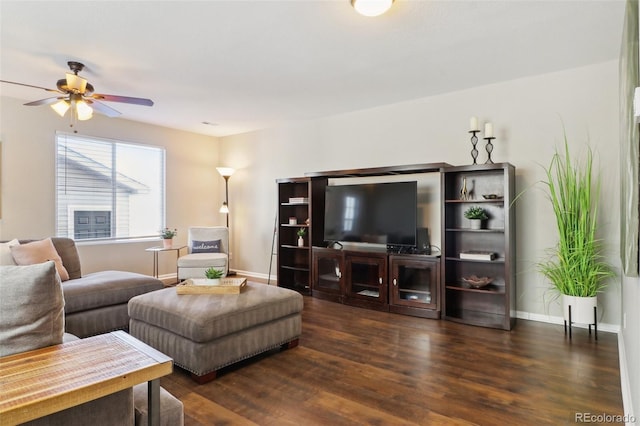 living room featuring ceiling fan, baseboards, and wood finished floors