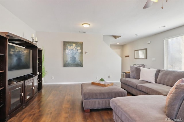 living area featuring ceiling fan, dark wood finished floors, and baseboards