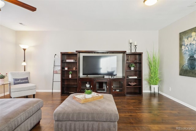 living room featuring visible vents, wood finished floors, a ceiling fan, and baseboards