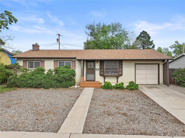 3605 Windsor Ave, Colorado Springs, CO 80907 - ranch-style house featuring a garage, driveway, a chimney, stucco siding, and roof with shingles