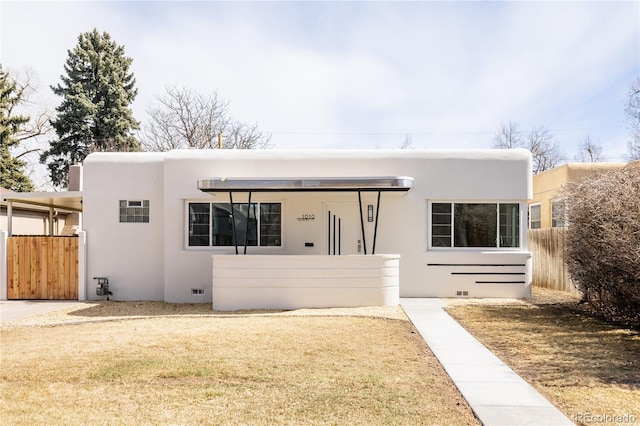 art deco inspired home featuring crawl space, stucco siding, and fence