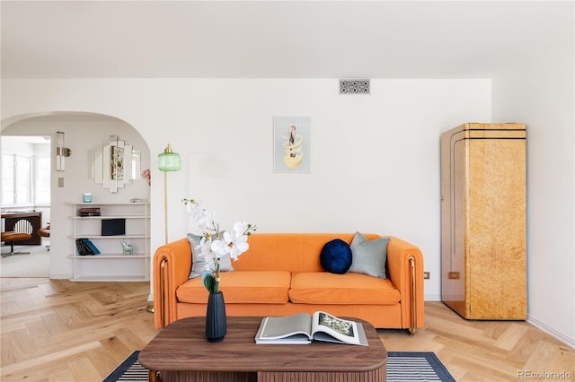 living room featuring arched walkways