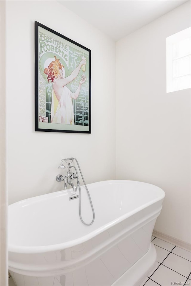 bathroom with tile patterned floors and a soaking tub