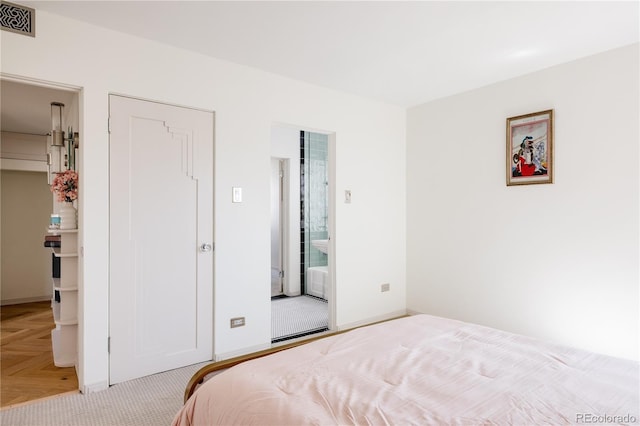 bedroom with visible vents and baseboards